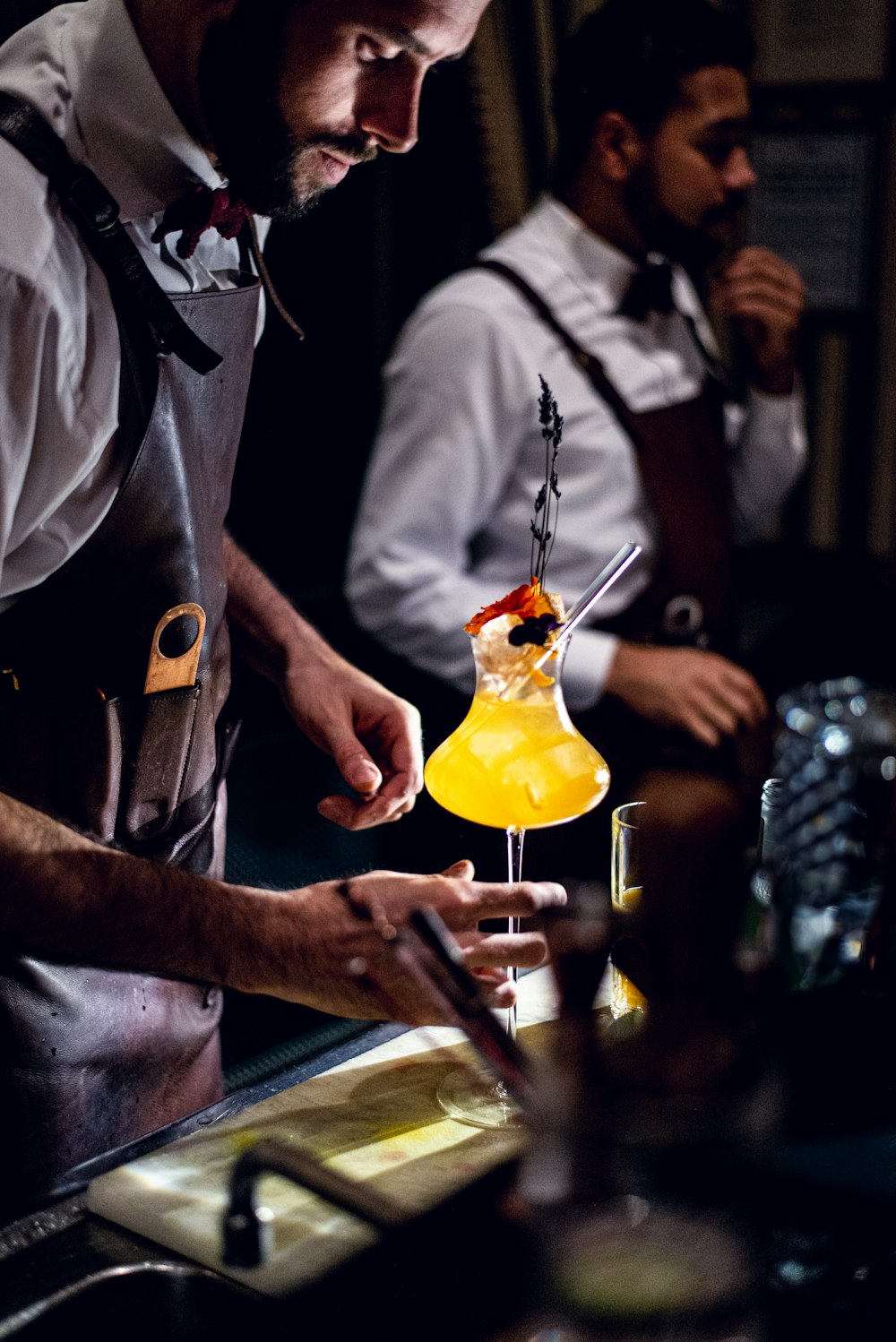 a man is making a cocktail at a bar