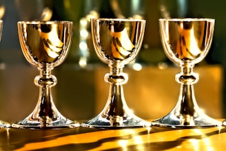 three gold chalice