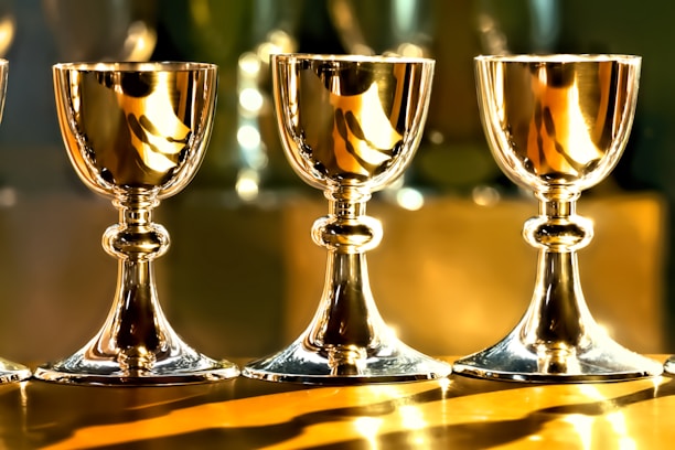 three gold chalice