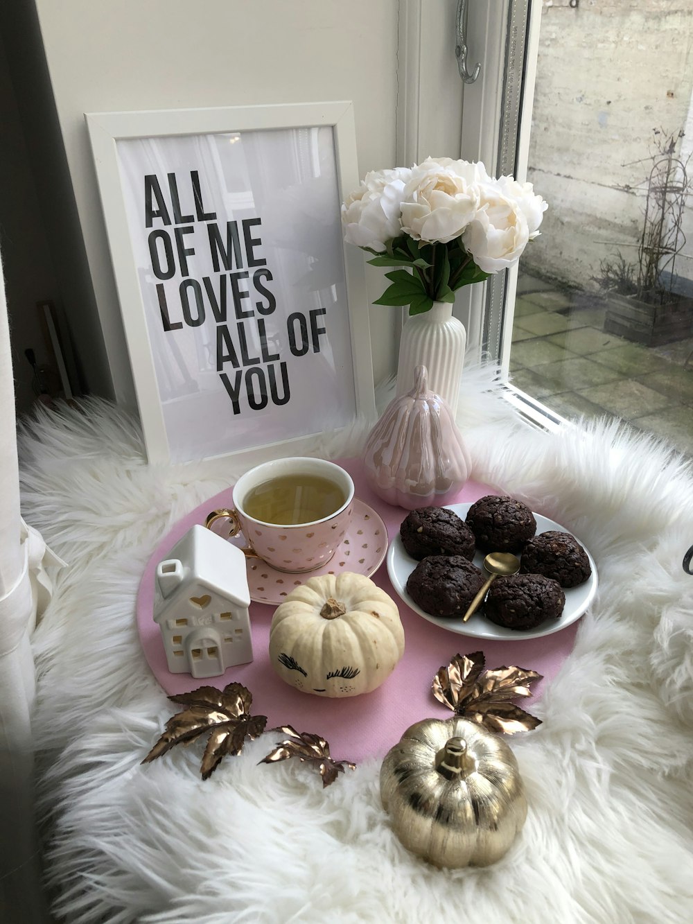 plate of dessert and tea on top of a table by the window