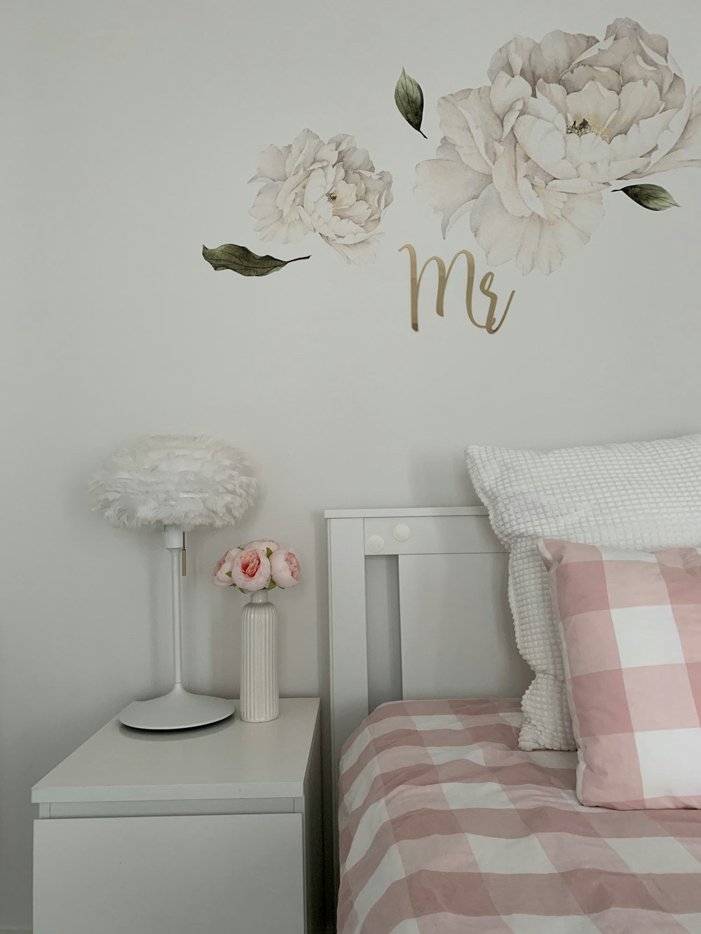 floral arrangements on nightstand beside bed