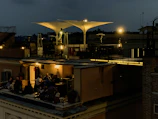 Guests enjoying a relaxed evening under string lights on the terrace.
