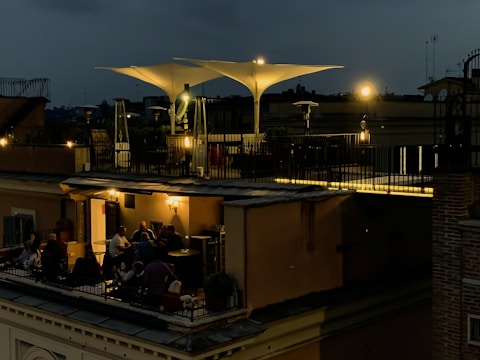 Nighttime view of a spacious terrace illuminated with soft, adjustable lighting.
