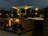 Guests enjoying drinks on the vibrant outdoor terrace under soft evening lights.