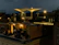 Guests enjoying drinks on the vibrant outdoor terrace under soft evening lights.