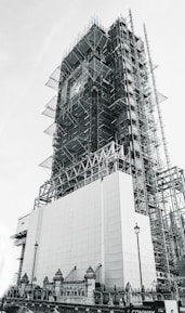 low-angle grayscale photography of an unfinished high-rise building