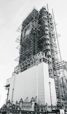 low-angle grayscale photography of an unfinished high-rise building