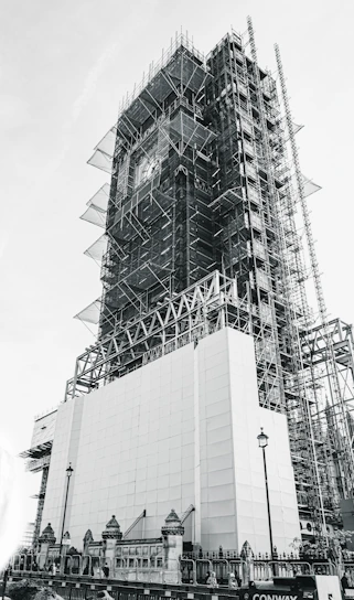 low-angle grayscale photography of an unfinished high-rise building