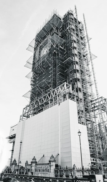 low-angle grayscale photography of an unfinished high-rise building