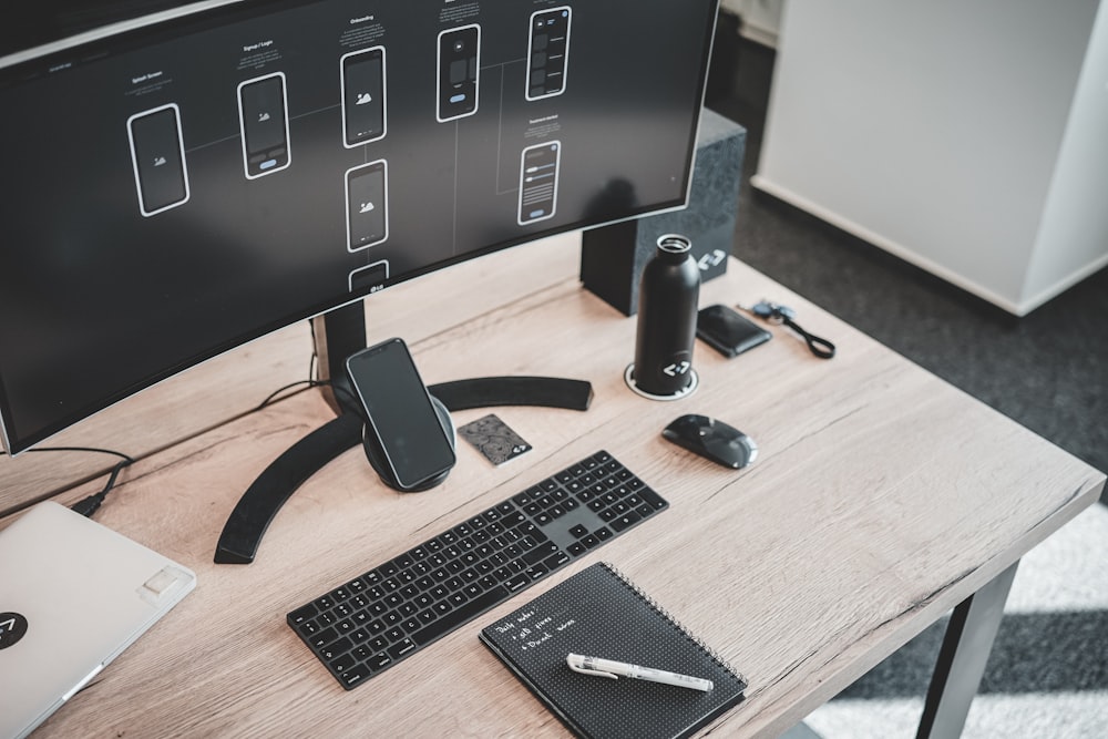 computer set turned-on on wooden table