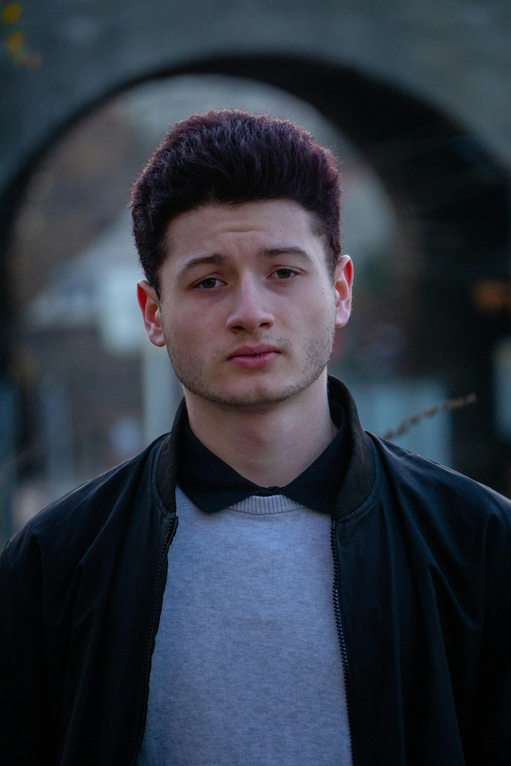 man in gray top and black zip-up jacket