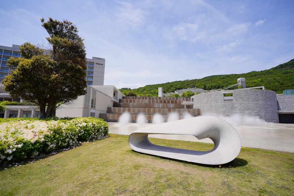 a sculpture in the middle of a grassy area
