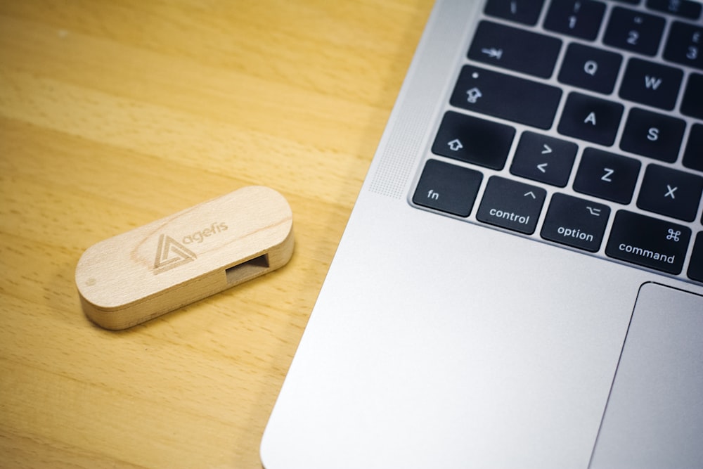 brown thumb drive beside MacBook