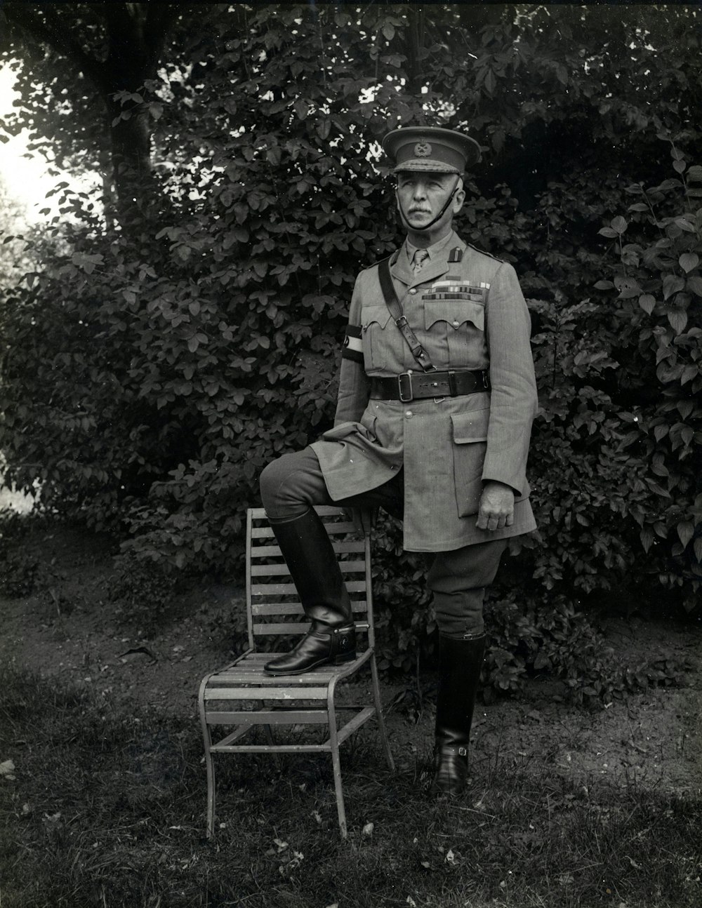 man standing with right foot on chair