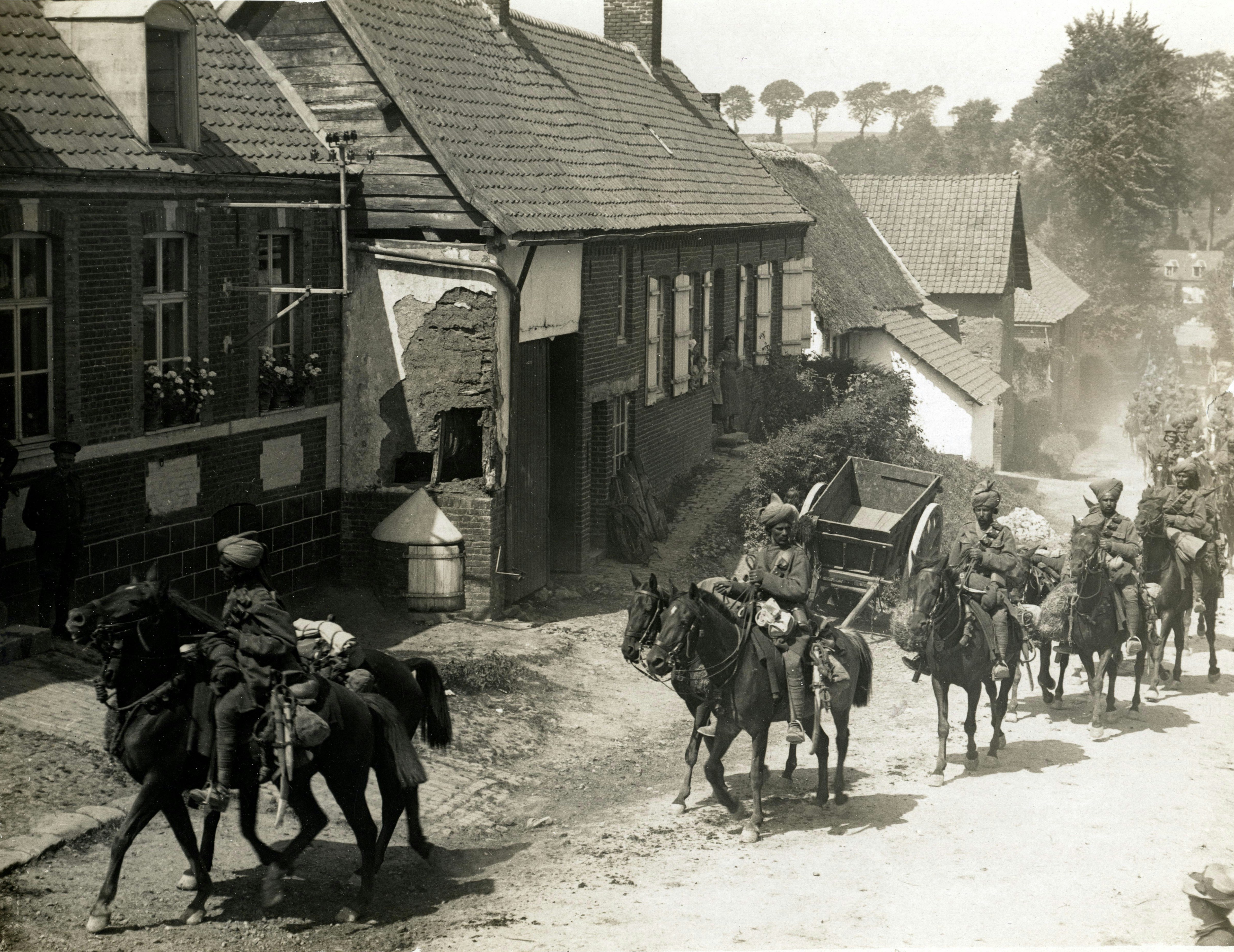 1914, World War 1. Indian cavalry marching through a French village. Photographer: H. D. Girdwood.