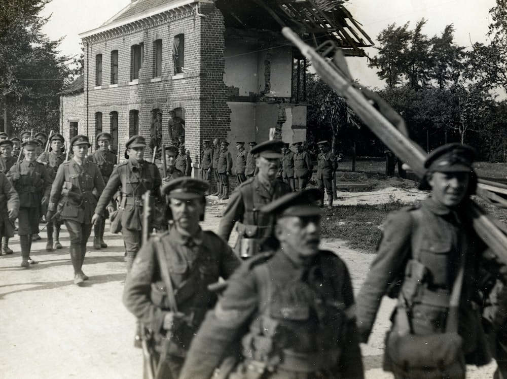 Grupo de fotografía en escala de grises de soldado caminando al aire libre