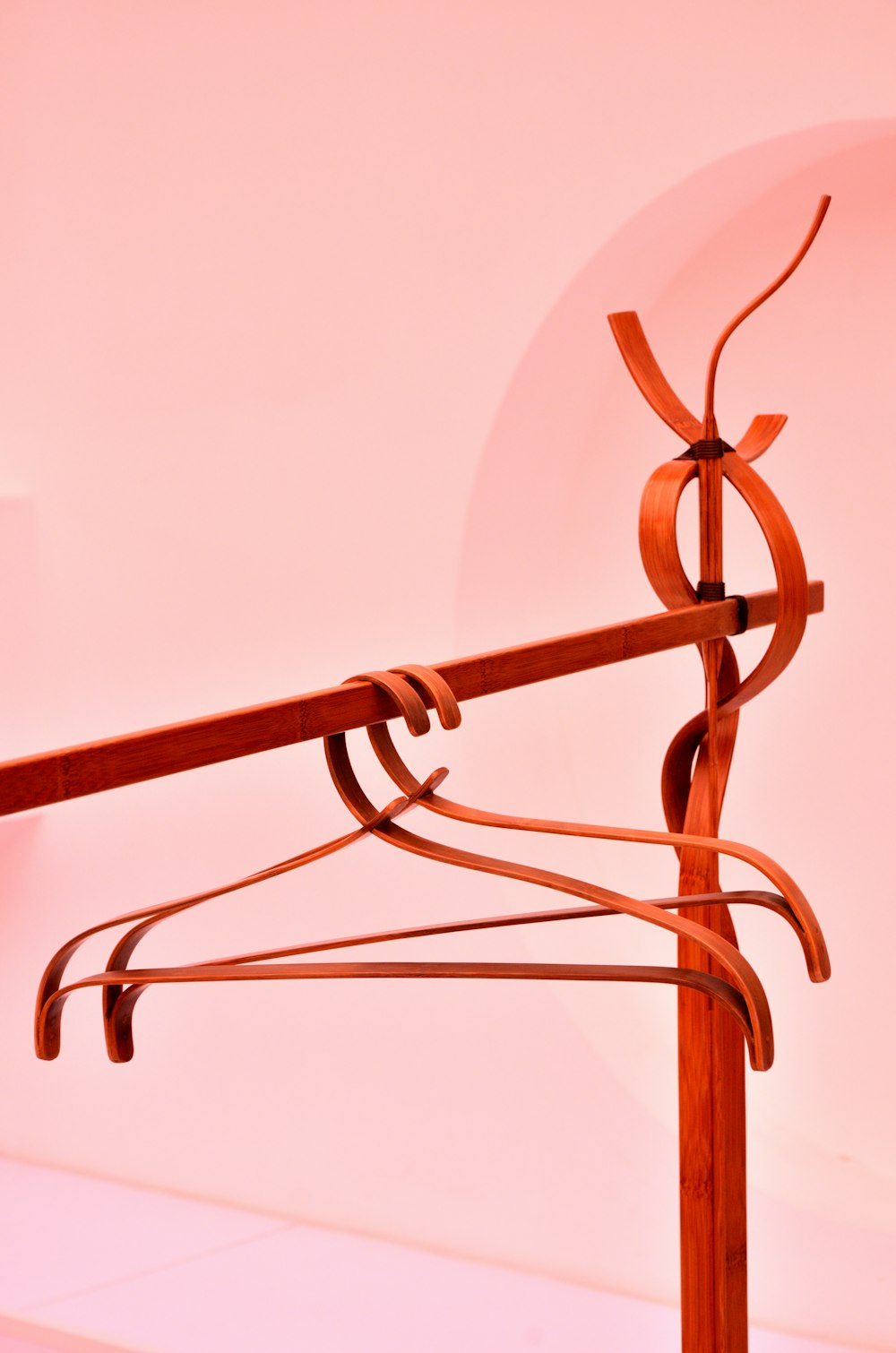 two orange clothes hanger on rack