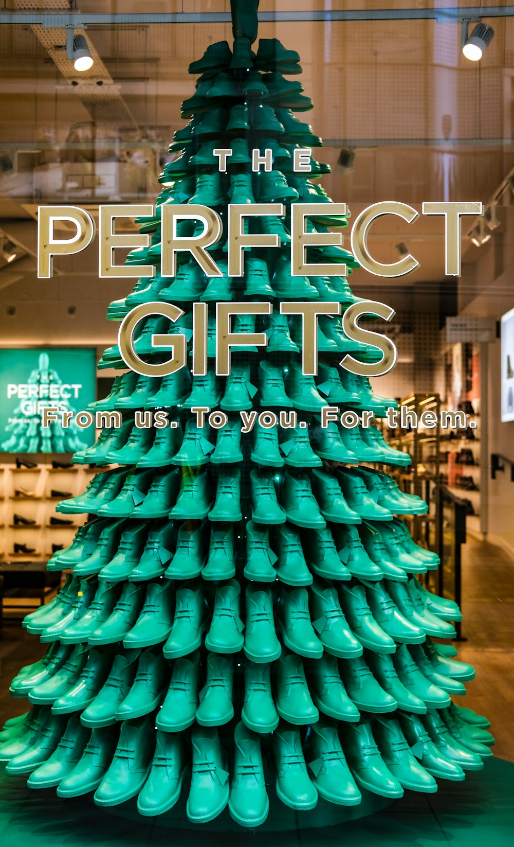 a green christmas tree made out of green shoes