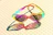 A close-up of a pair of vibrant sunglasses resting on a colorful ceramic plate from Clay Heart.