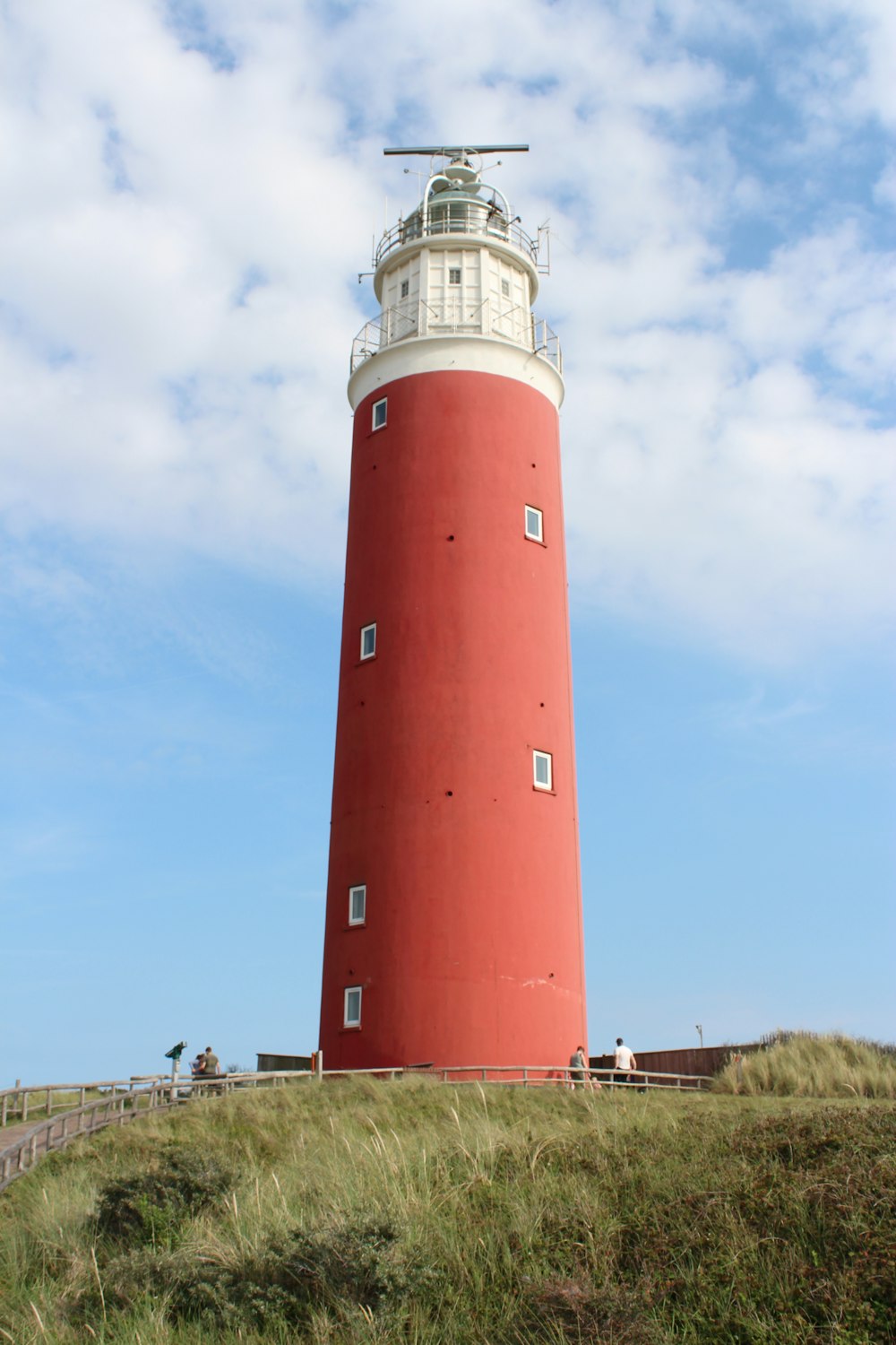 low-angle photography of a red and white lighthouse