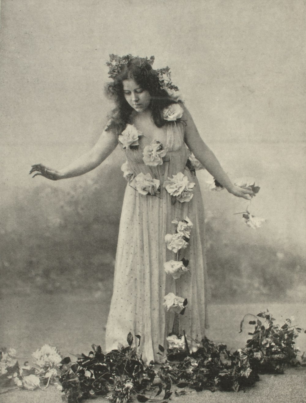 greyscale photo of woman holding flowers