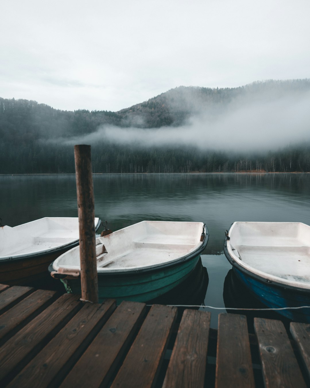 three blue boats on body of water