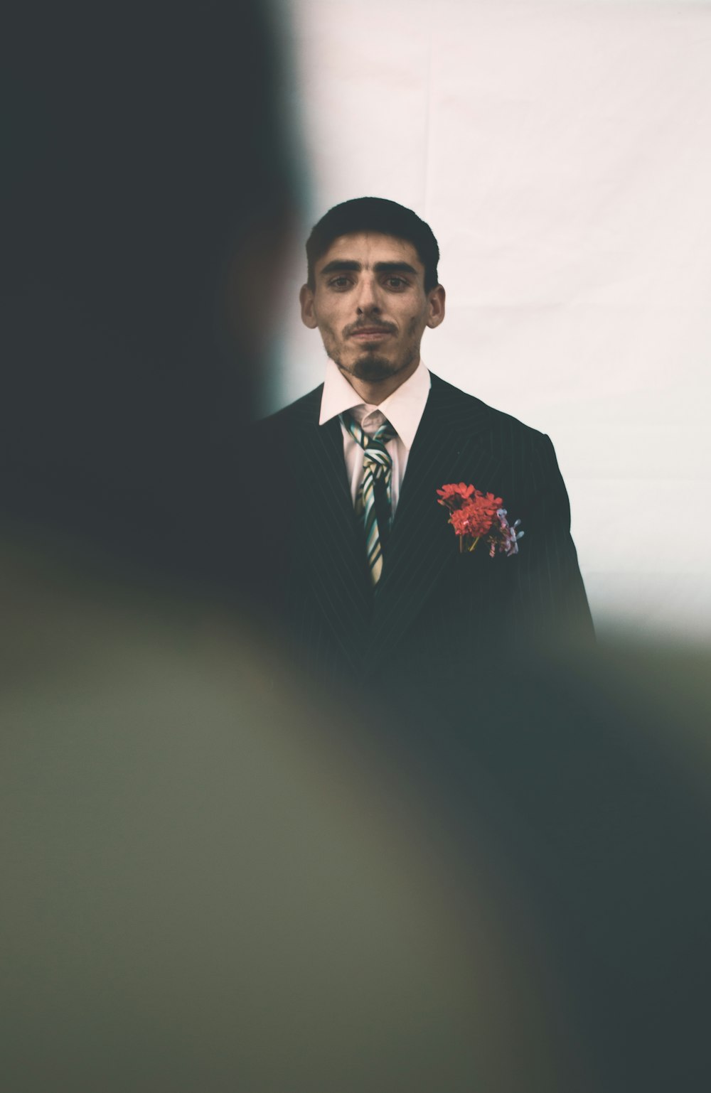 man wearing black and white suit