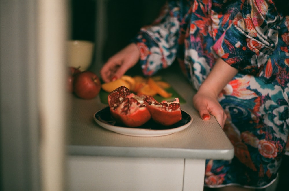 person standing beside fruits