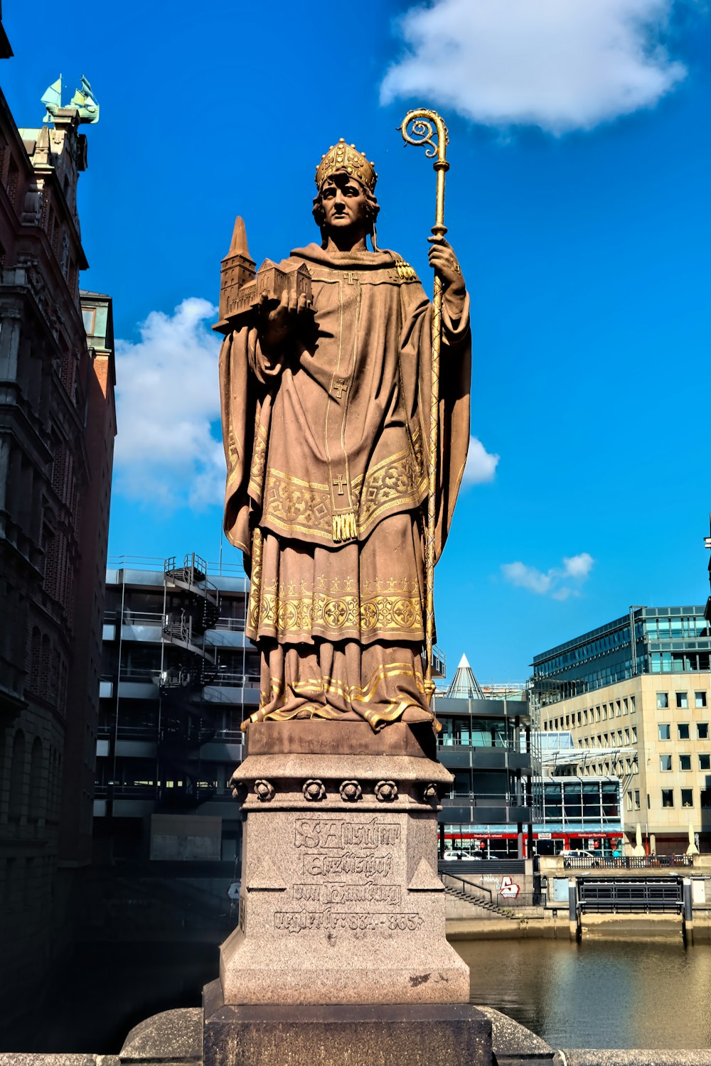 man holding wand statue