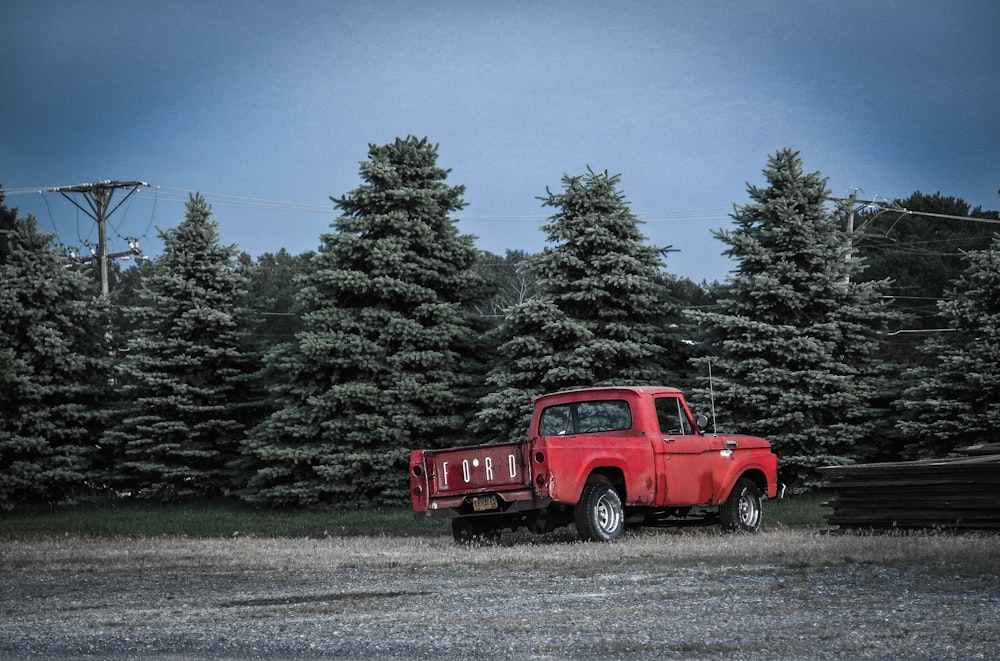 red single-cab pickup truck during daytime