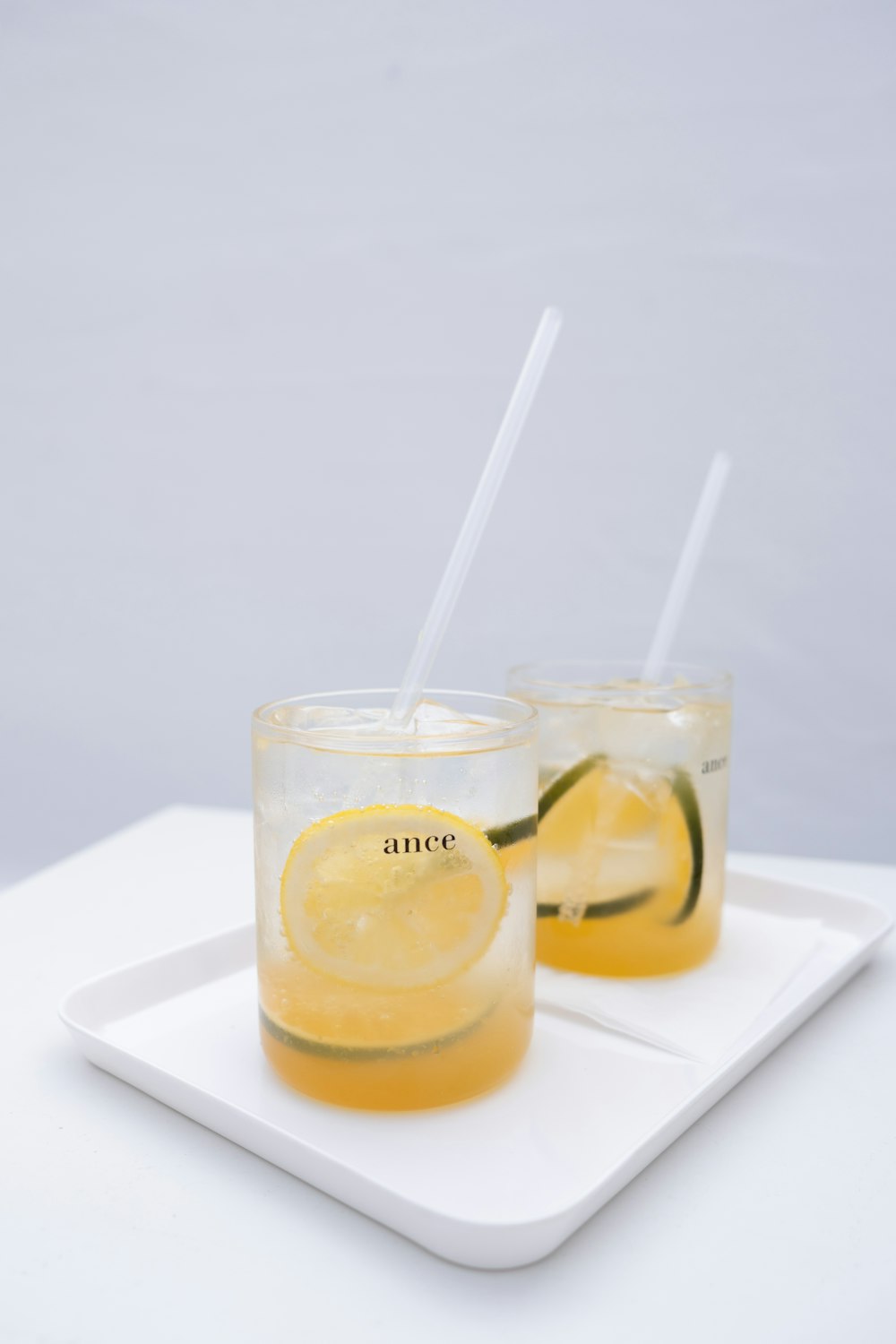 shallow focus photo of orange liquid in clear glass cup