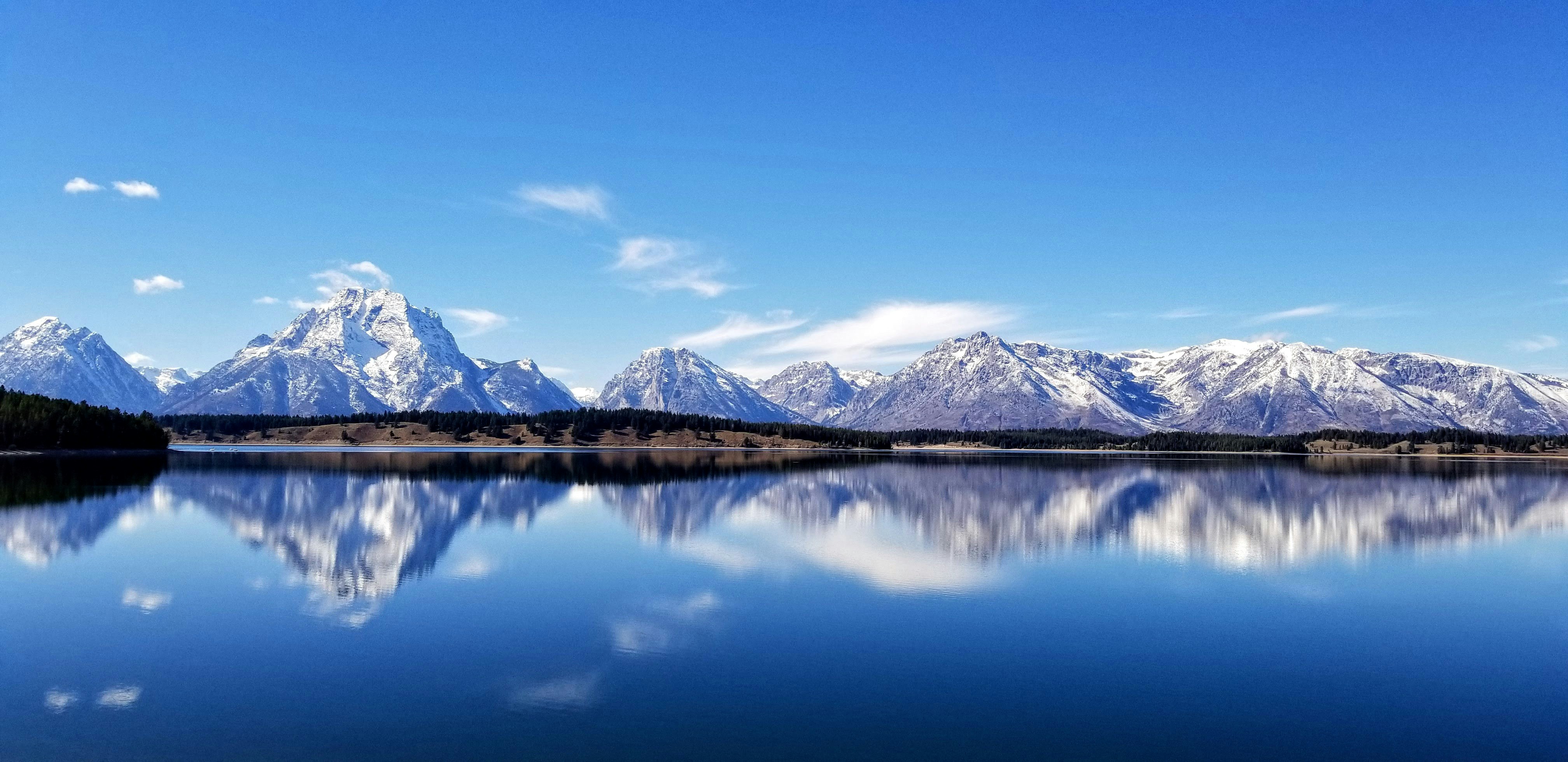 snow covered mountains near body of water, 