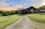 A rustic barn decorated with campaign signs and handmade banners in warm earthy tones.