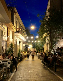 A bustling Middle Eastern street lined with vibrant cafes and restaurants.