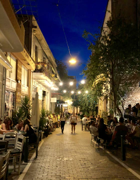 A bustling Middle Eastern street lined with vibrant cafes and restaurants.