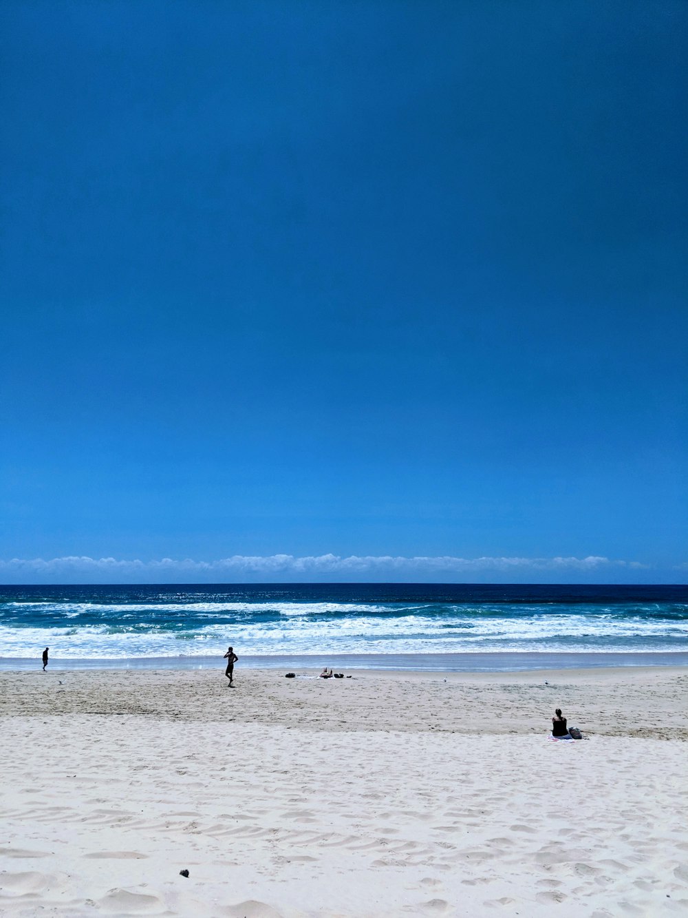 people standing on beach during daytime