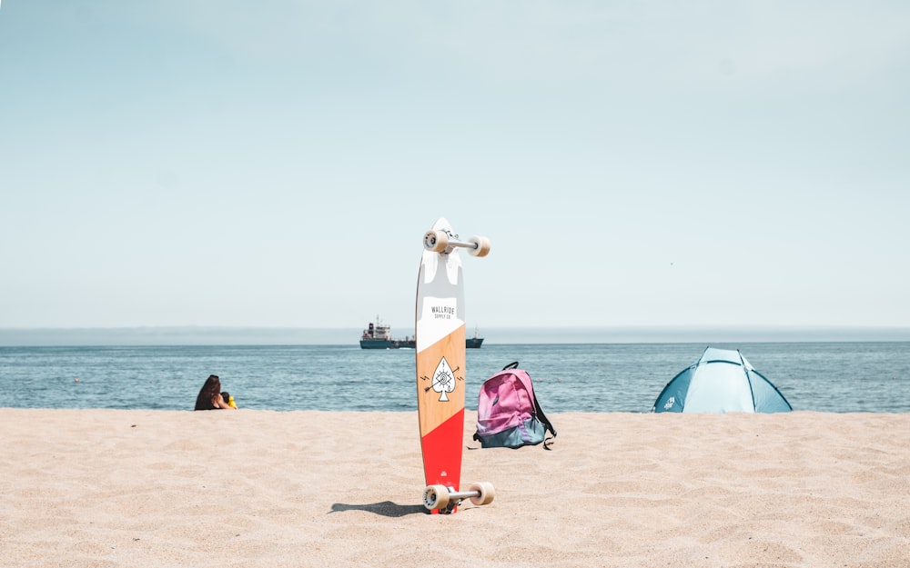 gray, brown, and red longboard