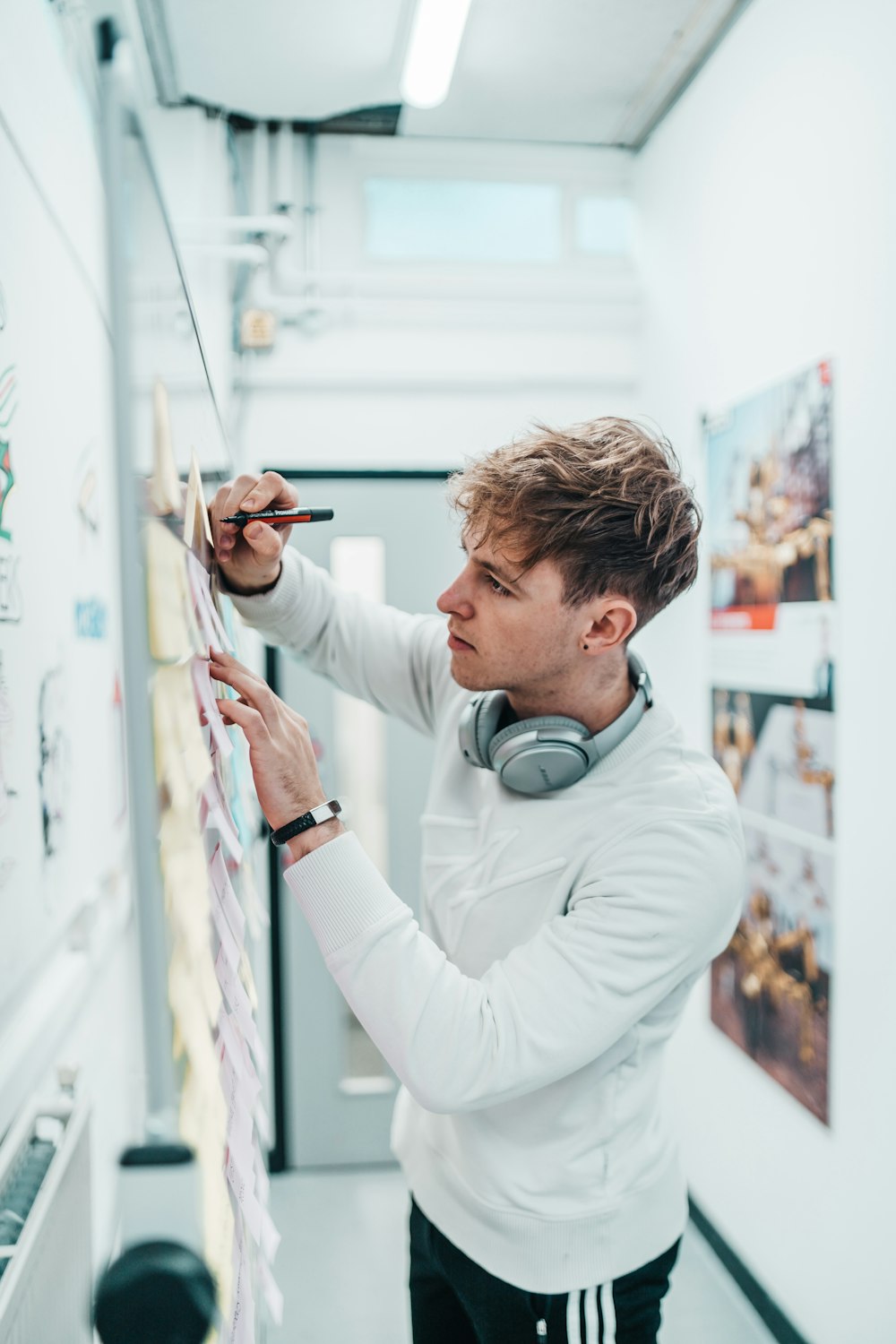 man with pen writing on wall