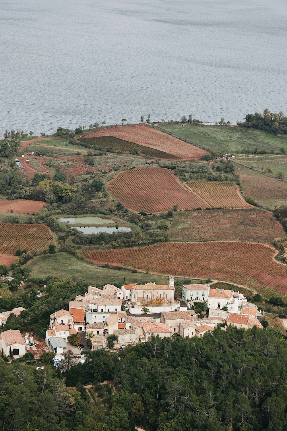 view of village by land fields during daytime