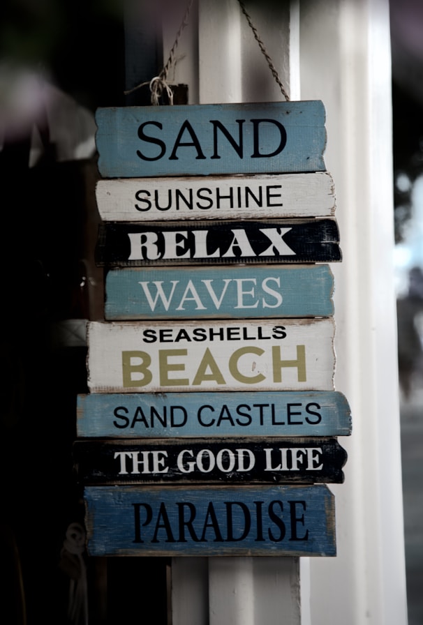 shallow focus photo of white and blue wooden signage