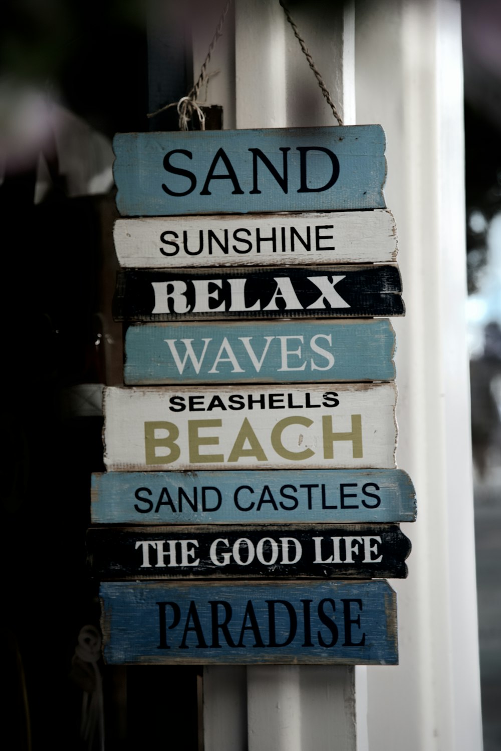 shallow focus photo of white and blue wooden signage