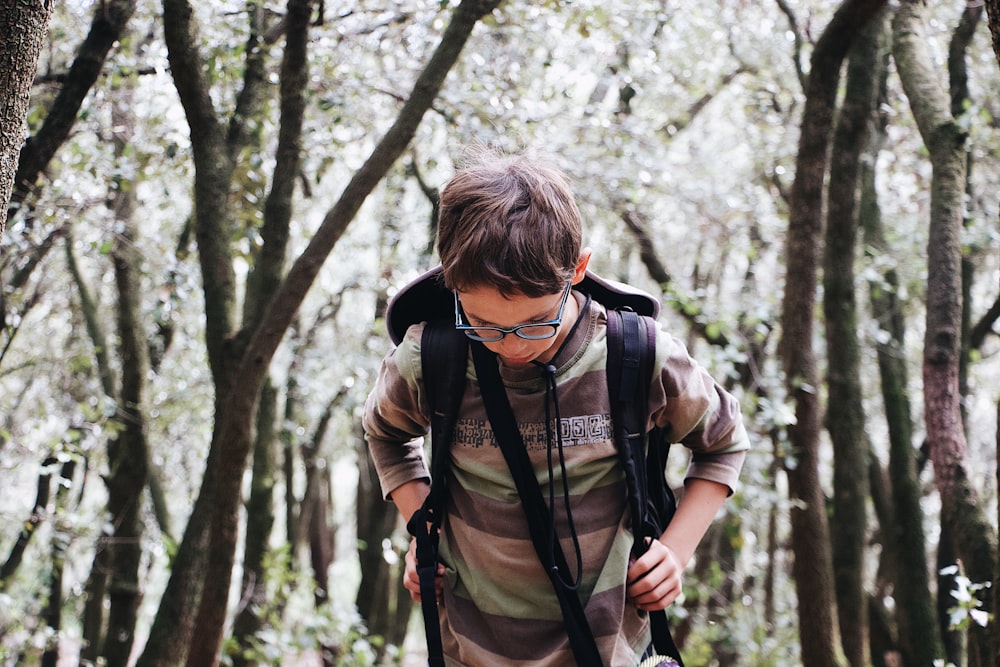 shallow focus photo of boy in brown long-sleeved shirt