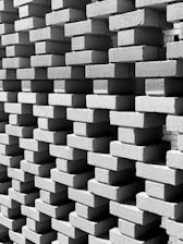 Close-up of masonry tools and bricks stacked neatly