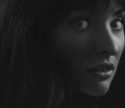 A close-up black and white portrait capturing deep emotion.