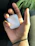 Close-up of a hand holding a neon blue silicone AirPods case with a smooth matte finish.