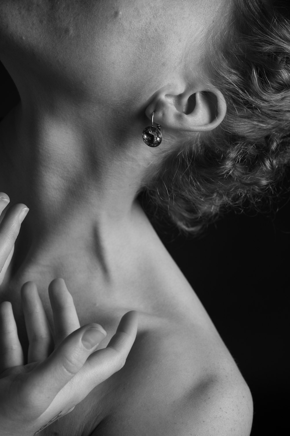 grayscale photography of topless person wearing earring