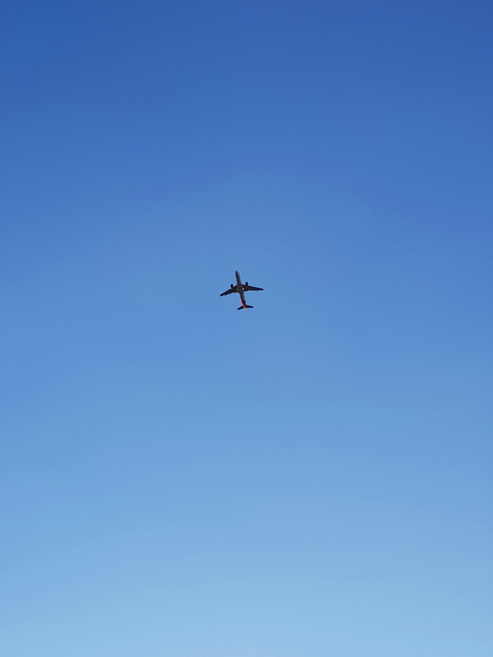 low-angle photography of an airplane in the sky