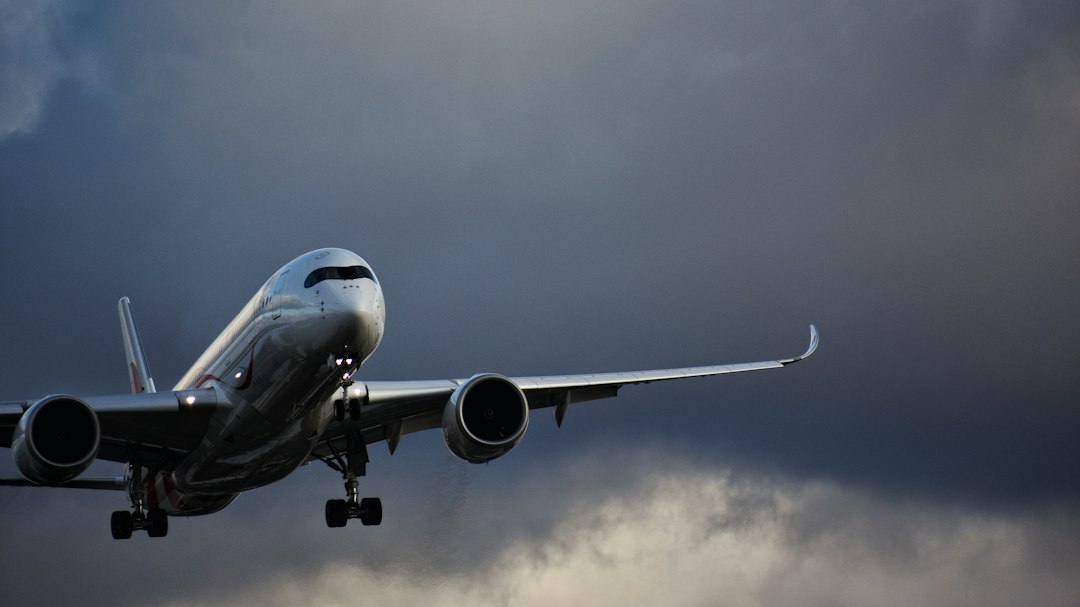 white airplane in mid air,