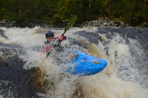 man rowing kayak