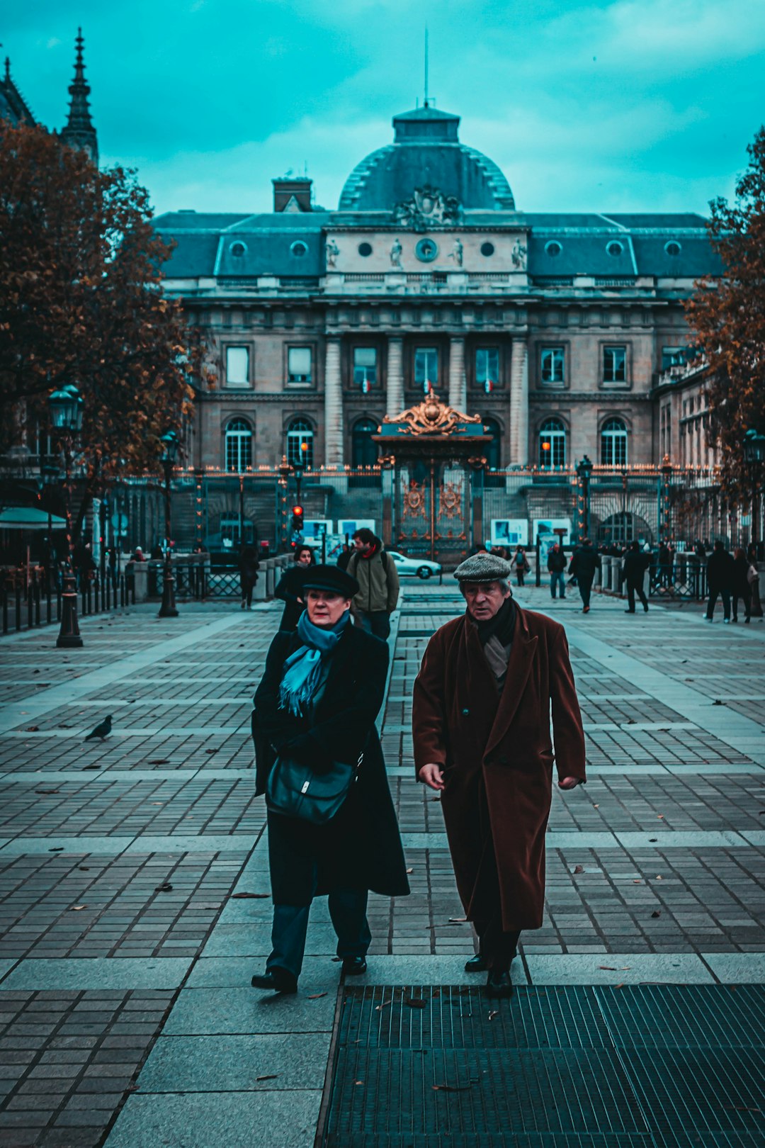 two people in coat walking side by side